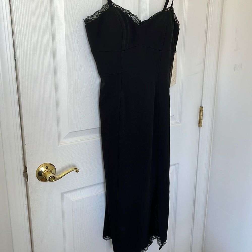 Black cocktail dress with lace trim and small slit